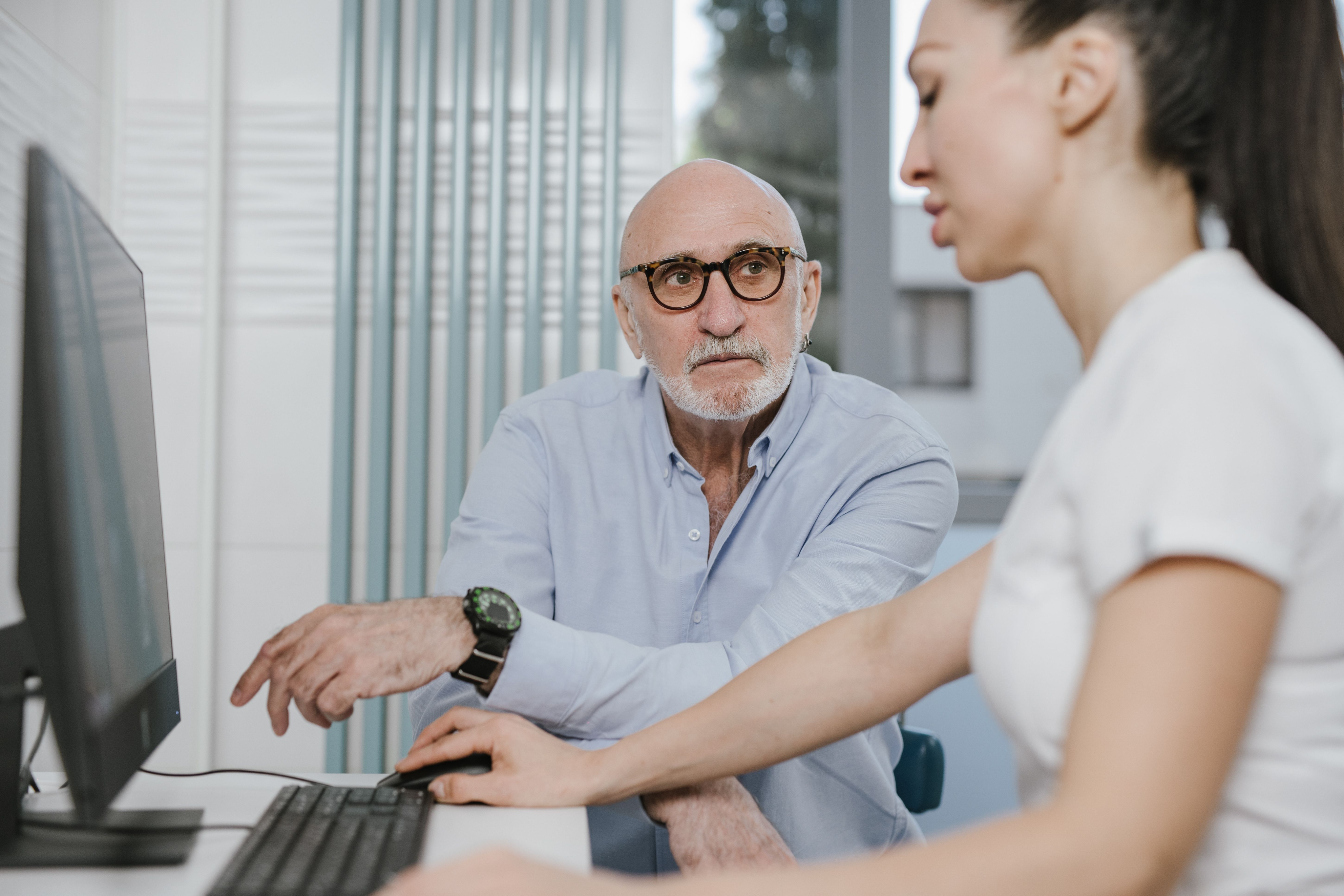 Healthcare provider meeting with a patient at a desk