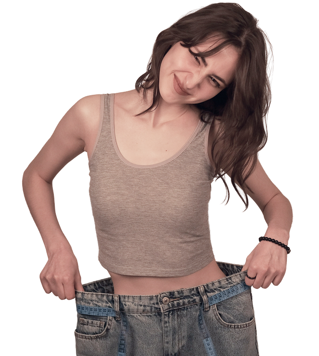 Woman smiling and holding oversized jeans after weight loss with GLP-1 therapy